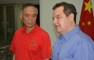 Minister Dacic and Ambassador Li Mancang watch the game of womens finals in volleyball